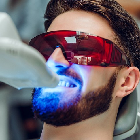 A man receiving in-office teeth whitening